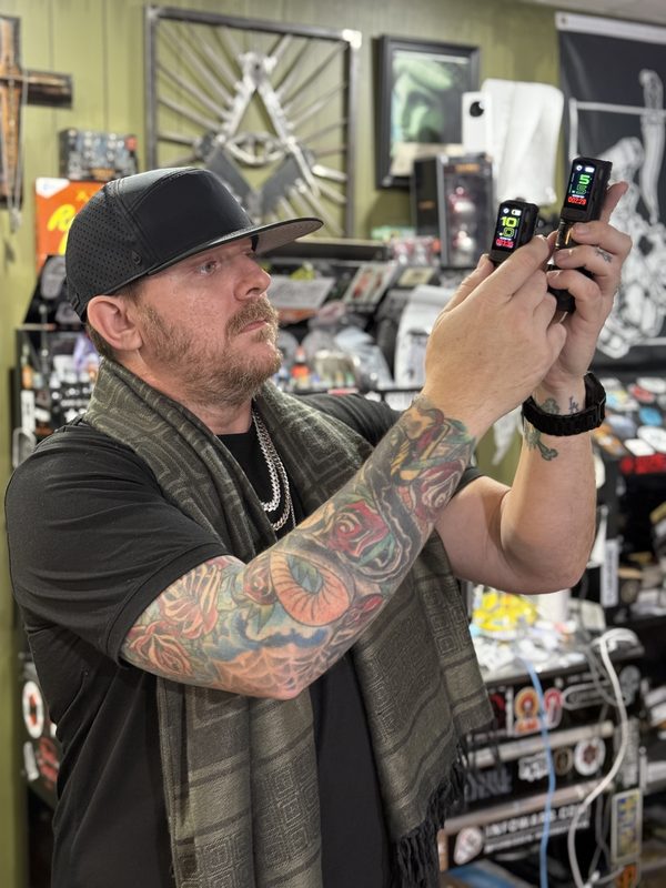 Lance Albright examining tattoo machines